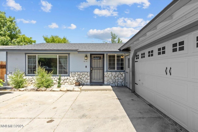 1510 E Slide Mountain Dr, Carson City, NV 89706 - ranch-style house featuring stone siding, concrete driveway, a garage, and a shingled roof