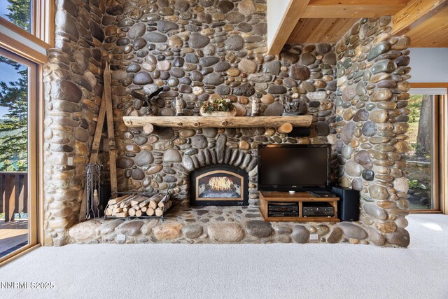 187 Yellow Jacket Rd, Glenbrook, NV 89413 - detailed view of carpet flooring, a lit fireplace, and a wood ceiling with exposed beams