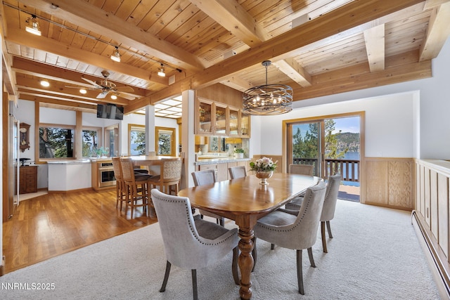 187 Yellow Jacket Rd, Glenbrook, NV 89413 - dining area featuring a wood ceiling with exposed beams, wainscoting, light colored carpet, baseboard heating, and a chandelier