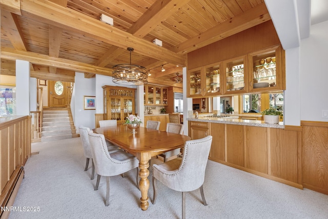 187 Yellow Jacket Rd, Glenbrook, NV 89413 - dining space featuring a wood ceiling with exposed beams, plenty of natural light, a baseboard radiator, light colored carpet, and wood walls