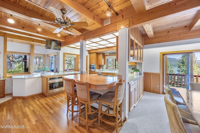 187 Yellow Jacket Rd, Glenbrook, NV 89413 - dining space with a wooden ceiling with exposed beams, healthy amount of natural light, track lighting, light wood-type flooring, and a wainscoted wall