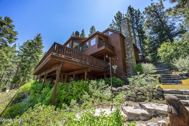 187 Yellow Jacket Rd, Glenbrook, NV 89413 - rear view of property with a chimney, stairs, and a deck
