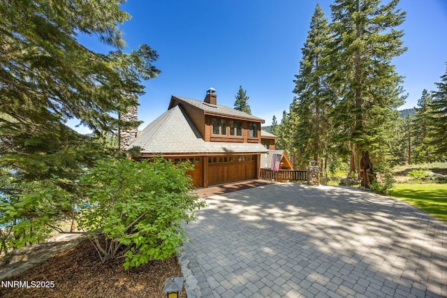 187 Yellow Jacket Rd, Glenbrook, NV 89413 - view of front of house featuring a chimney, a garage, and decorative driveway