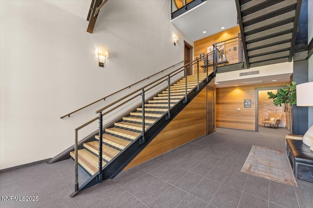 17 Beach Club Dr # 213, Stateline, NV 89449 - staircase with a high ceiling, tile patterned flooring, and wood walls