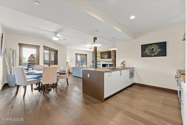 17 Beach Club Dr # 213, Stateline, NV 89449 - kitchen featuring a peninsula, wood finished floors, ceiling fan, white cabinetry, and recessed lighting