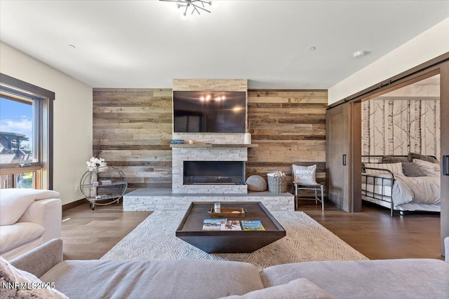 17 Beach Club Dr # 213, Stateline, NV 89449 - living area featuring wood walls, wood finished floors, a barn door, a stone fireplace, and an accent wall