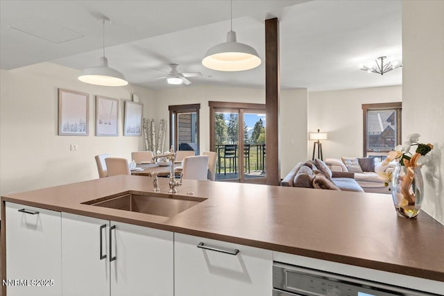 17 Beach Club Dr # 213, Stateline, NV 89449 - kitchen featuring dark countertops, open floor plan, decorative light fixtures, and white cabinetry