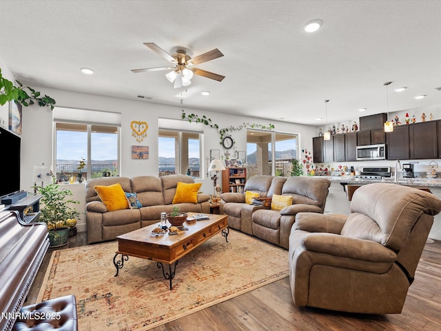2217 Millville Dr, Spanish Springs, NV 89441 - living area with hardwood / wood-style floors, ceiling fan, and recessed lighting