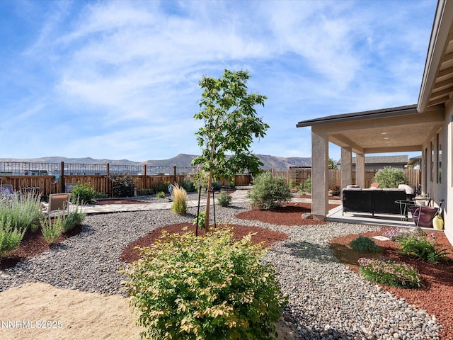 2217 Millville Dr, Spanish Springs, NV 89441 - fenced backyard with a patio, a mountain view, and an outdoor living space