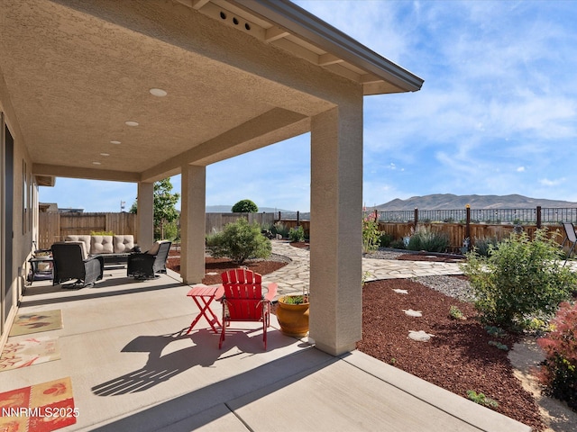 2217 Millville Dr, Spanish Springs, NV 89441 - fenced backyard with outdoor lounge area, a patio, and a mountain view
