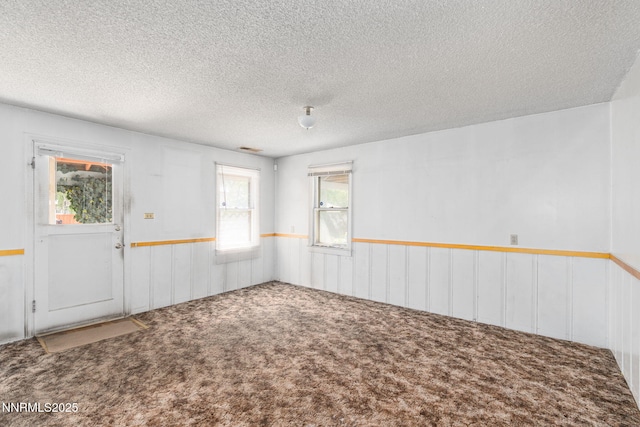 5385 Carol Dr, Sun Valley, NV 89433 - carpeted spare room featuring a wainscoted wall and a textured ceiling