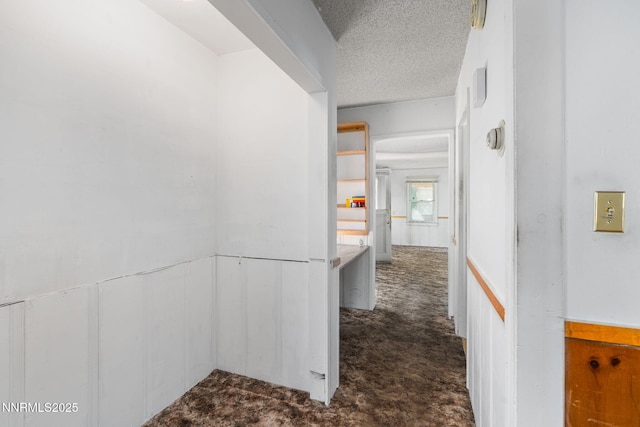 5385 Carol Dr, Sun Valley, NV 89433 - hallway with dark carpet and a textured ceiling