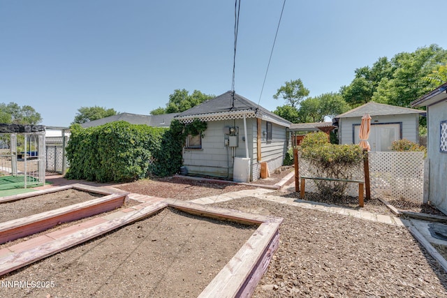 5385 Carol Dr, Sun Valley, NV 89433 - view of yard with a vegetable garden and an outdoor structure