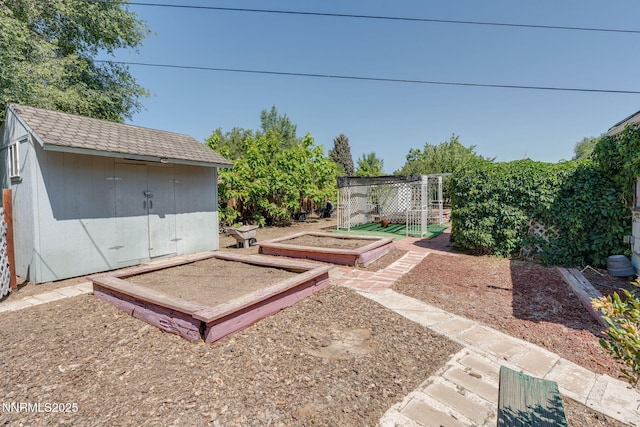 5385 Carol Dr, Sun Valley, NV 89433 - view of yard featuring a vegetable garden and a storage unit