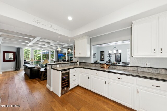 1064 Lucerne Way, Incline Village, NV 89451 - kitchen featuring beverage cooler, open floor plan, light wood-style flooring, white cabinetry, and coffered ceiling
