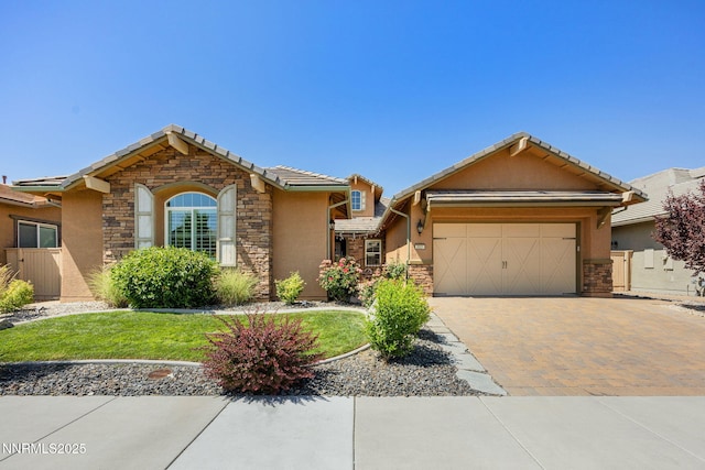 2021 Neviekay Ln, Reno, NV 89521 - ranch-style house with stone siding, stucco siding, an attached garage, and decorative driveway