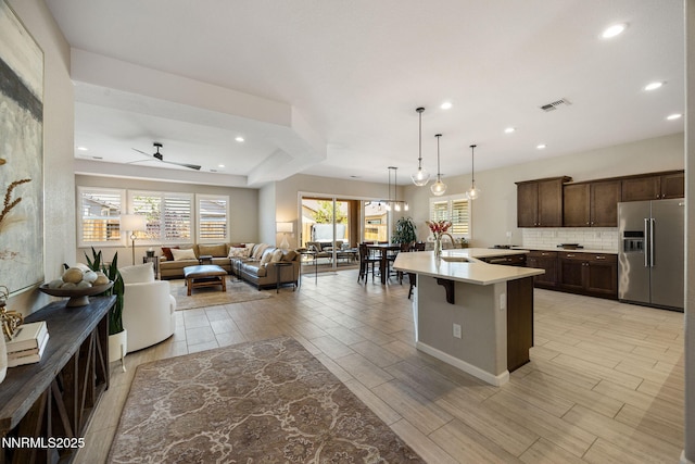 2021 Neviekay Ln, Reno, NV 89521 - kitchen with high quality fridge, dark brown cabinets, open floor plan, a ceiling fan, and light countertops