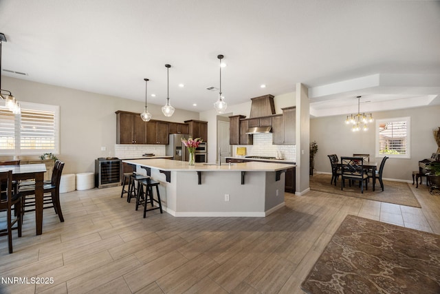2021 Neviekay Ln, Reno, NV 89521 - kitchen featuring stainless steel fridge with ice dispenser, backsplash, light countertops, a large island, and a kitchen breakfast bar