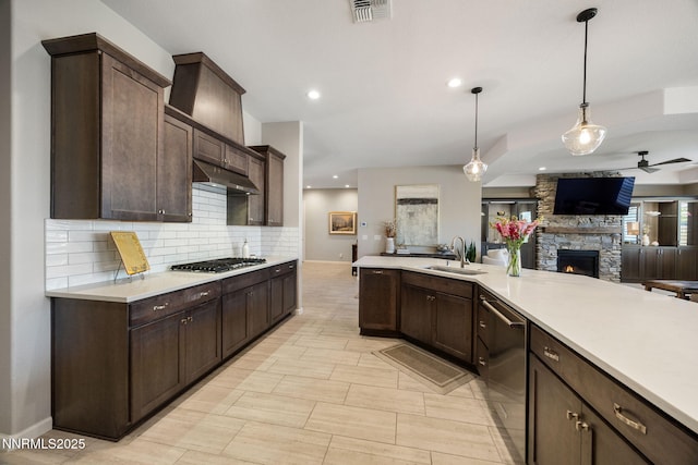 2021 Neviekay Ln, Reno, NV 89521 - kitchen with open floor plan, appliances with stainless steel finishes, tasteful backsplash, dark brown cabinets, and light countertops