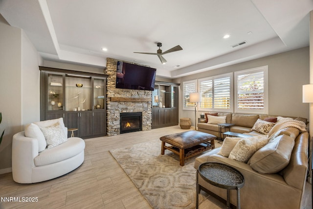 2021 Neviekay Ln, Reno, NV 89521 - living room with a fireplace, ceiling fan, wood finished floors, a tray ceiling, and recessed lighting