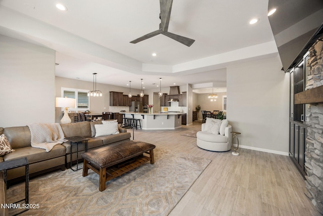 2021 Neviekay Ln, Reno, NV 89521 - living area featuring ceiling fan, light wood-type flooring, a chandelier, recessed lighting, and a fireplace
