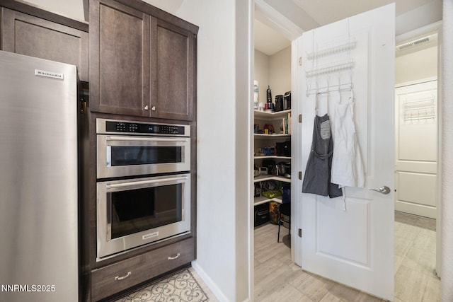 2021 Neviekay Ln, Reno, NV 89521 - kitchen featuring stainless steel appliances, dark brown cabinets, and light wood-style floors