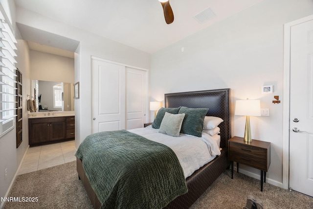 2021 Neviekay Ln, Reno, NV 89521 - bedroom with a closet, light colored carpet, ensuite bathroom, a ceiling fan, and light tile patterned floors