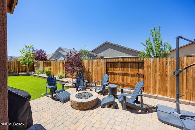 2021 Neviekay Ln, Reno, NV 89521 - fenced backyard featuring a fire pit, a patio area, and a grill