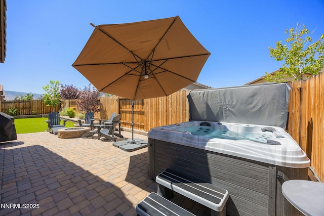 2021 Neviekay Ln, Reno, NV 89521 - fenced backyard with a hot tub, an outdoor fire pit, a patio area, and grilling area