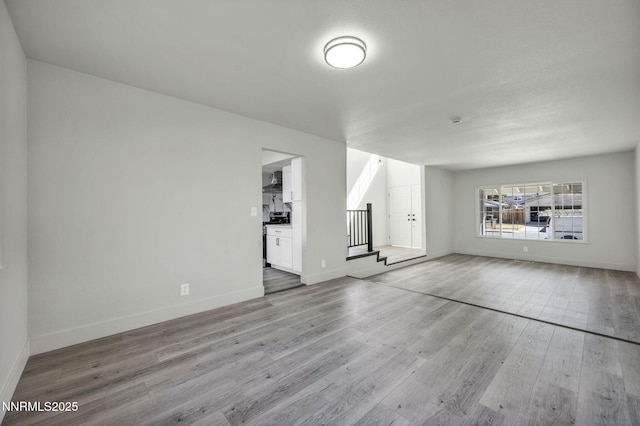 4565 Rio Encantado Ln, Reno, NV 89502 - unfurnished living room featuring stairs and wood finished floors