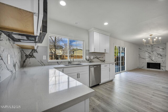 4565 Rio Encantado Ln, Reno, NV 89502 - kitchen with stainless steel dishwasher, a chandelier, recessed lighting, white cabinets, and backsplash