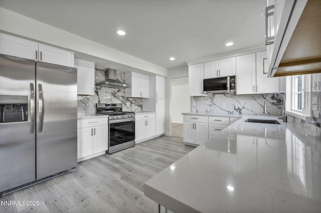 4565 Rio Encantado Ln, Reno, NV 89502 - kitchen with stainless steel appliances, wall chimney exhaust hood, light stone counters, tasteful backsplash, and recessed lighting