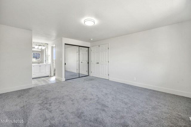 4565 Rio Encantado Ln, Reno, NV 89502 - unfurnished bedroom featuring carpet, ensuite bath, and two closets