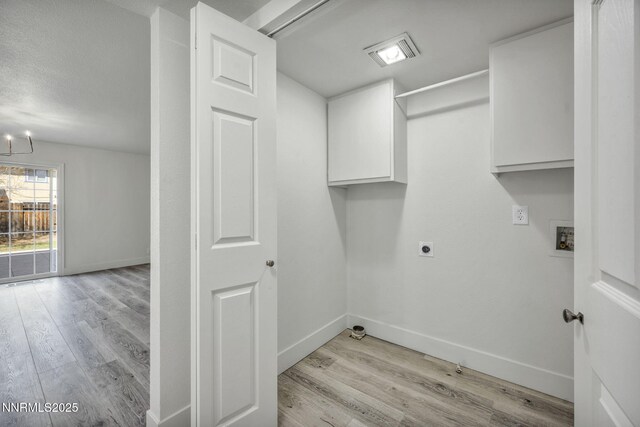 4565 Rio Encantado Ln, Reno, NV 89502 - laundry area featuring electric dryer hookup, cabinet space, light wood-style flooring, a chandelier, and hookup for a washing machine