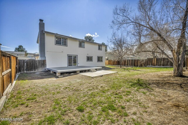 4565 Rio Encantado Ln, Reno, NV 89502 - rear view of property featuring a fenced backyard, a deck, a chimney, and a patio area