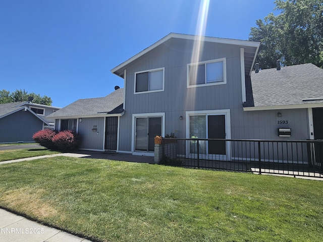 1591 York Way, Sparks, NV 89431 - view of side of home with a shingled roof and a yard