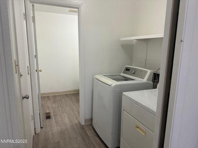 1591 York Way, Sparks, NV 89431 - washroom featuring washer and clothes dryer and light wood-type flooring