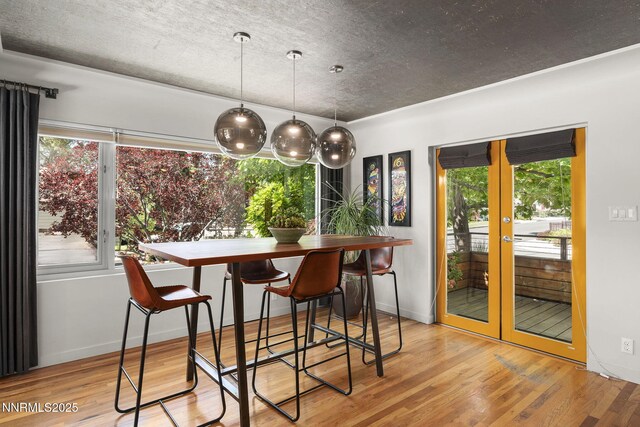 1296 Nixon Ave, Reno, NV 89509 - dining area with french doors, wood finished floors, and a textured ceiling