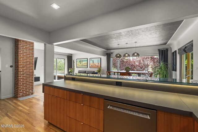 1296 Nixon Ave, Reno, NV 89509 - kitchen featuring stainless steel dishwasher, light wood-type flooring, dark countertops, modern cabinets, and open floor plan