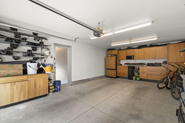 1296 Nixon Ave, Reno, NV 89509 - garage with high end fridge, a garage door opener, and a workshop area