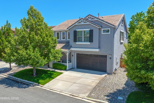 7470 Windswept Loop, Sparks, NV 89436 - view of front of home with stucco siding, concrete driveway, an attached garage, a tile roof, and covered porch