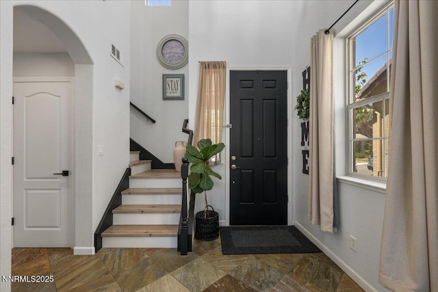 7470 Windswept Loop, Sparks, NV 89436 - foyer entrance featuring arched walkways, stairway, and a towering ceiling