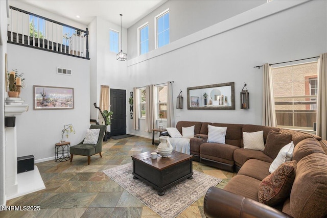 7470 Windswept Loop, Sparks, NV 89436 - living area with stone tile flooring and a towering ceiling