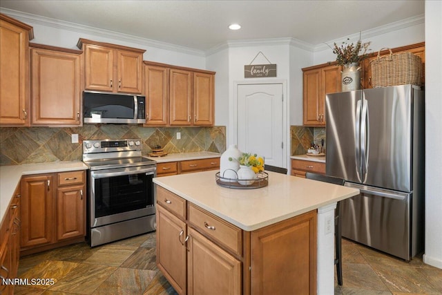 7470 Windswept Loop, Sparks, NV 89436 - kitchen featuring appliances with stainless steel finishes, a kitchen island, light countertops, ornamental molding, and brown cabinets
