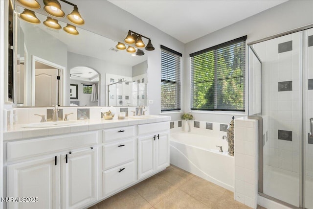 7470 Windswept Loop, Sparks, NV 89436 - full bath featuring a garden tub, a shower stall, double vanity, and tile patterned floors