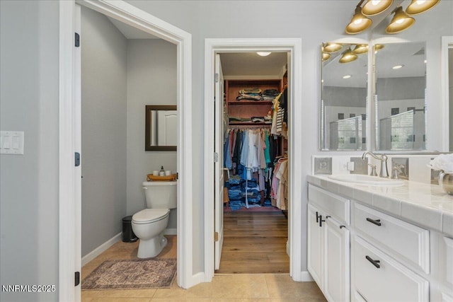7470 Windswept Loop, Sparks, NV 89436 - bathroom with vanity, a chandelier, tile patterned flooring, a spacious closet, and a walk in shower