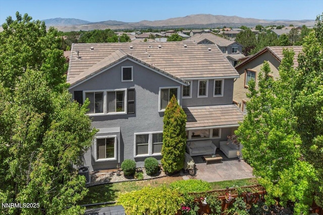 7470 Windswept Loop, Sparks, NV 89436 - back of house with a patio area, stucco siding, and a mountain view