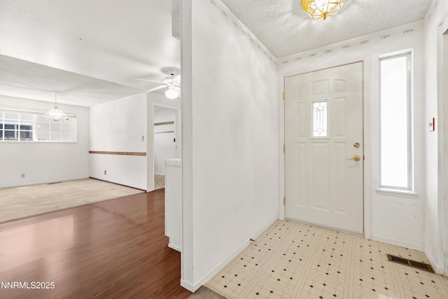 2960 Santa Ana Dr, Reno, NV 89502 - foyer entrance with a textured ceiling, ceiling fan, a chandelier, and wood finished floors