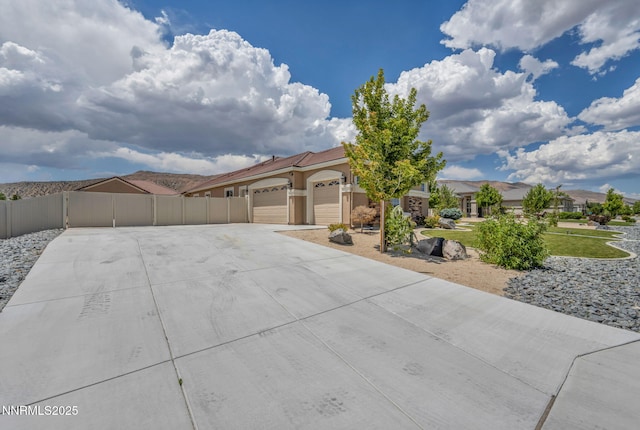 11575 Anthem Dr, Spanish Springs, NV 89441 - view of front facade featuring concrete driveway, an attached garage, stucco siding, and a gate