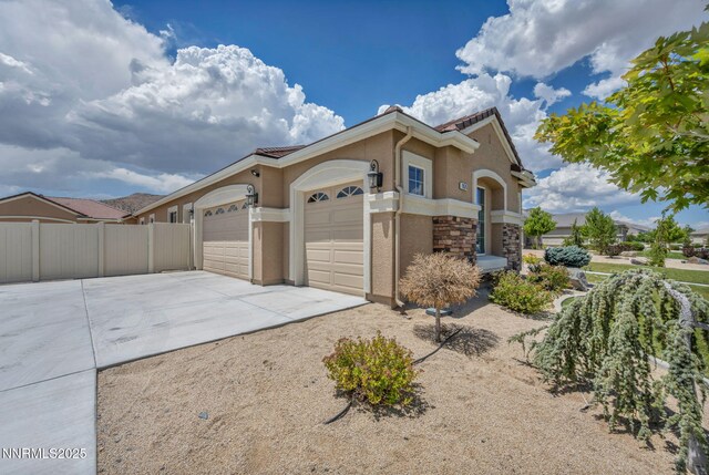 11575 Anthem Dr, Spanish Springs, NV 89441 - view of front of home with driveway, a garage, and stucco siding